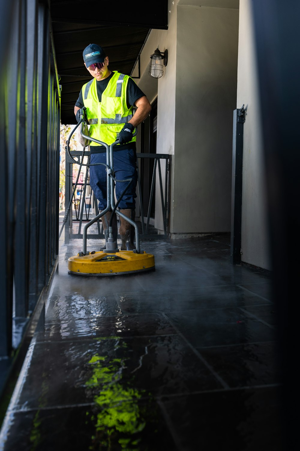 Technician cleaning a corridor floor
