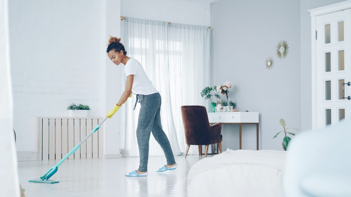 Technician cleaning a bright interior floor