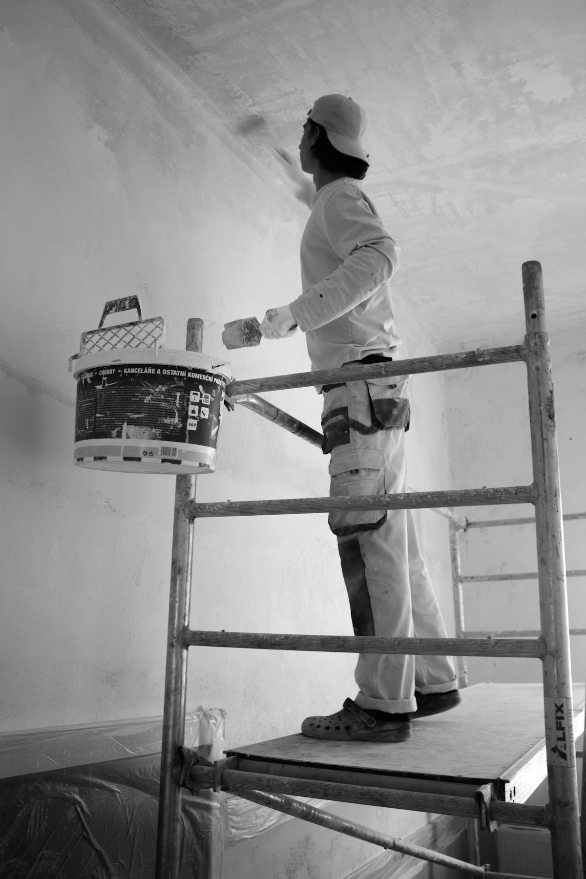 Painter rolling fresh coating onto a wall