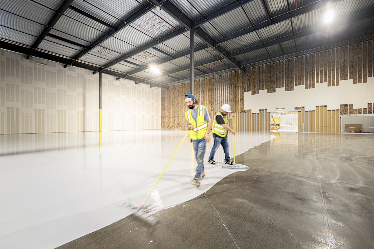 Crew applying a new coating to a large concrete floor